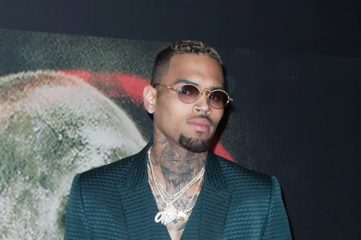 Chris Brown performs onstage under concert lighting