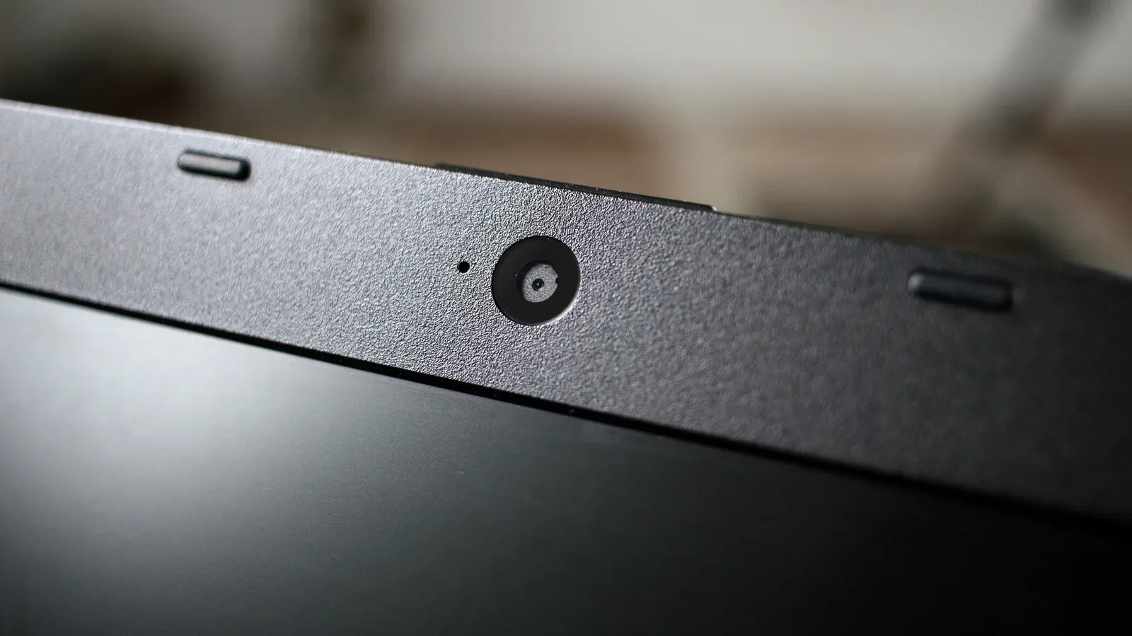A laptop user facing a window to improve built-in webcam lighting