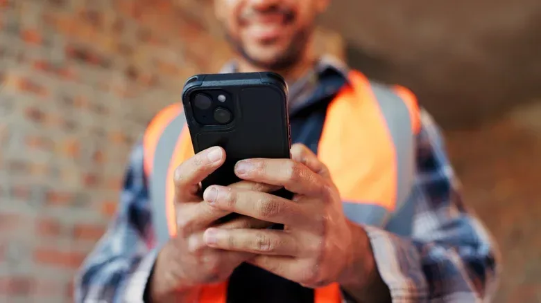 A person reviewing a PDF form on a phone before adding a signature