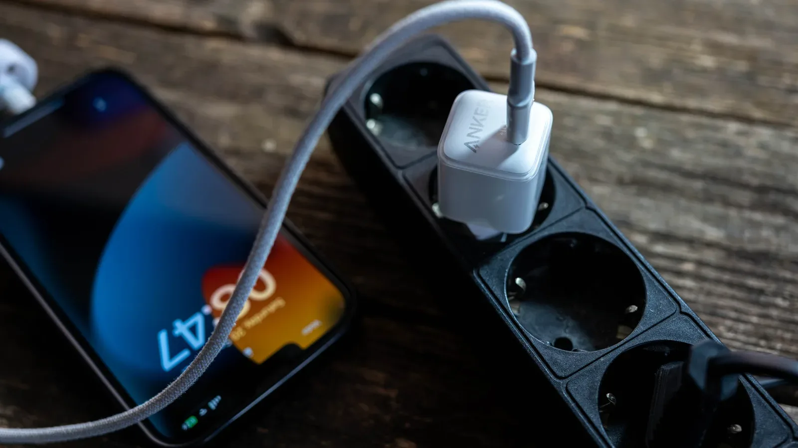 Anker PowerIQ charger connected to a device with charging wattage shown