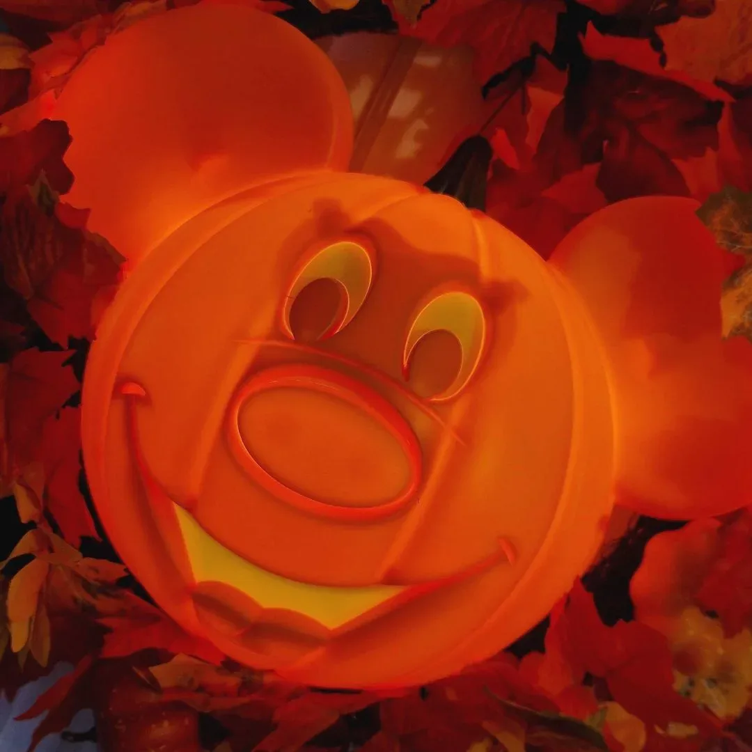 Halloween-themed Disney collectible items on a display shelf