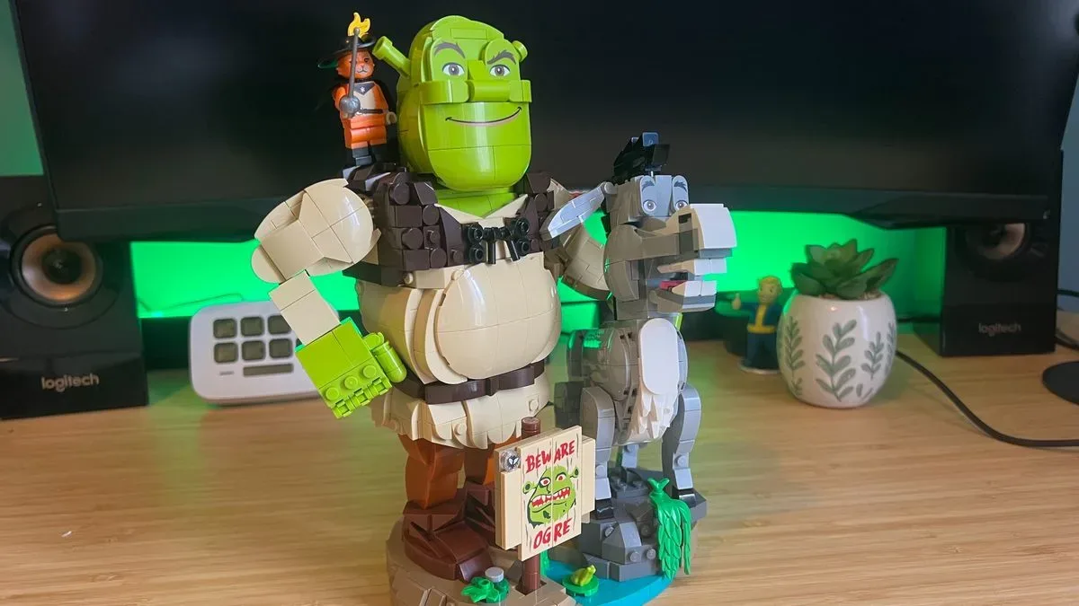 Lego Shrek, Donkey & Puss in Boots set on a wooden desk with green backlighting