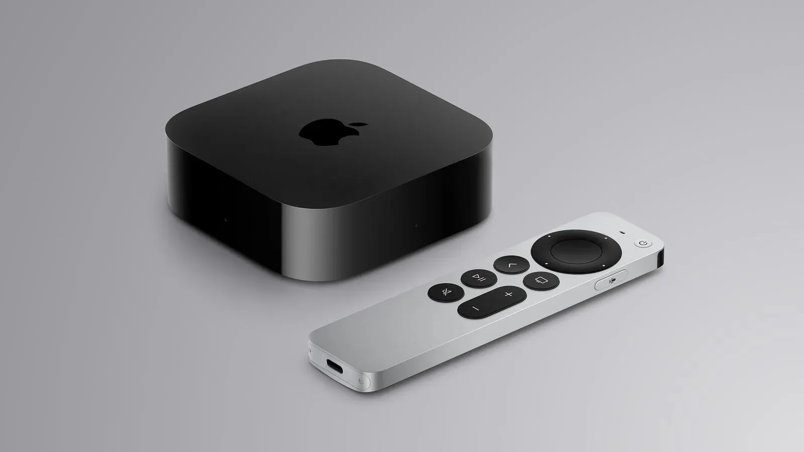 Apple TV 4K and two HomePod mini speakers arranged as a living-room entertainment setup
