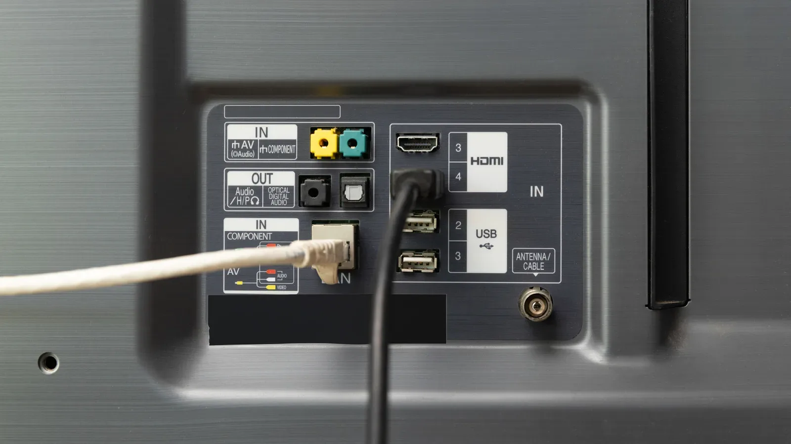 Ethernet cable connected behind a smart TV in a home entertainment setup