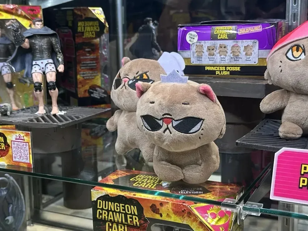 Dungeon Crawler Carl action figures displayed alongside Princess Donut plushies
