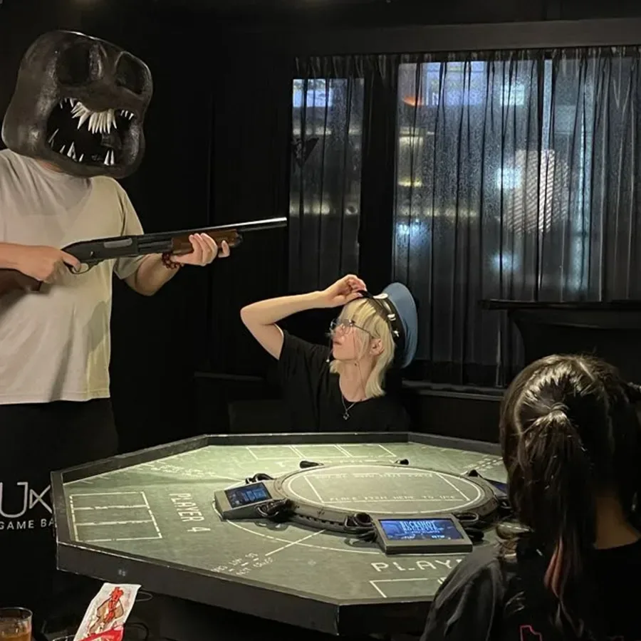 A masked host at Ukiyo Game Bar’s non-lethal Buckshot Roulette-inspired table experience in Tokyo