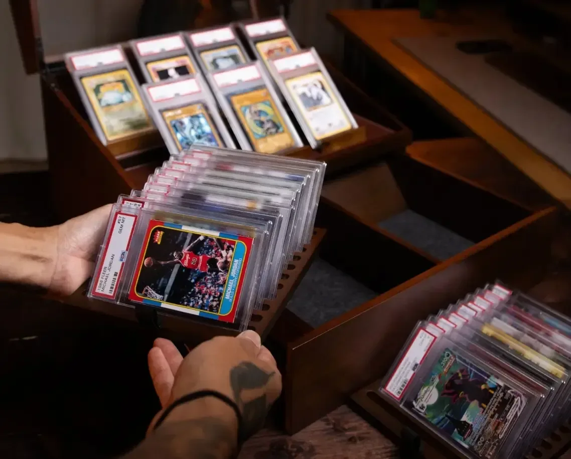 Holme & Hadfield Trade Deck tabletop display holding seven featured trading cards above drawer storage