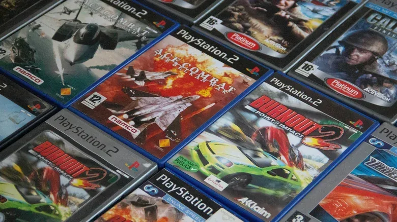 PlayStation 2 game boxes lined up in neat rows. Several Burnout and Ace Combat games.