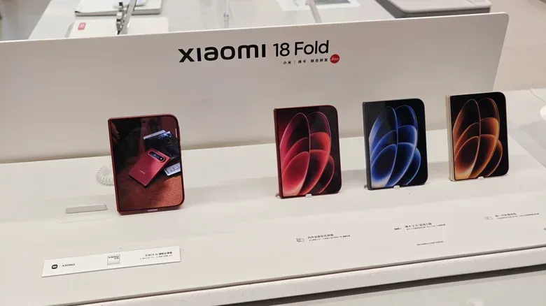 The Xiaomi 18 Fold, shown in various colors on a store display table.