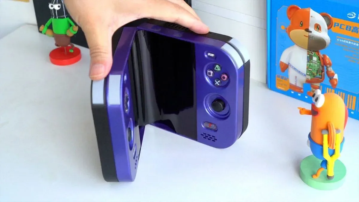 Foldable PlayStation 2 Duo handheld opened to show its LCD and custom controls