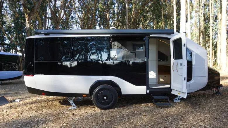 Pebble Flow RV interior with rear desk and Murphy bed