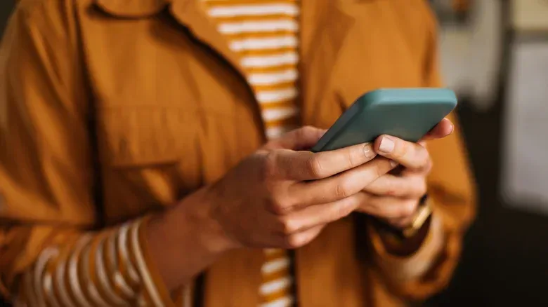 A person typing on a smartphone.