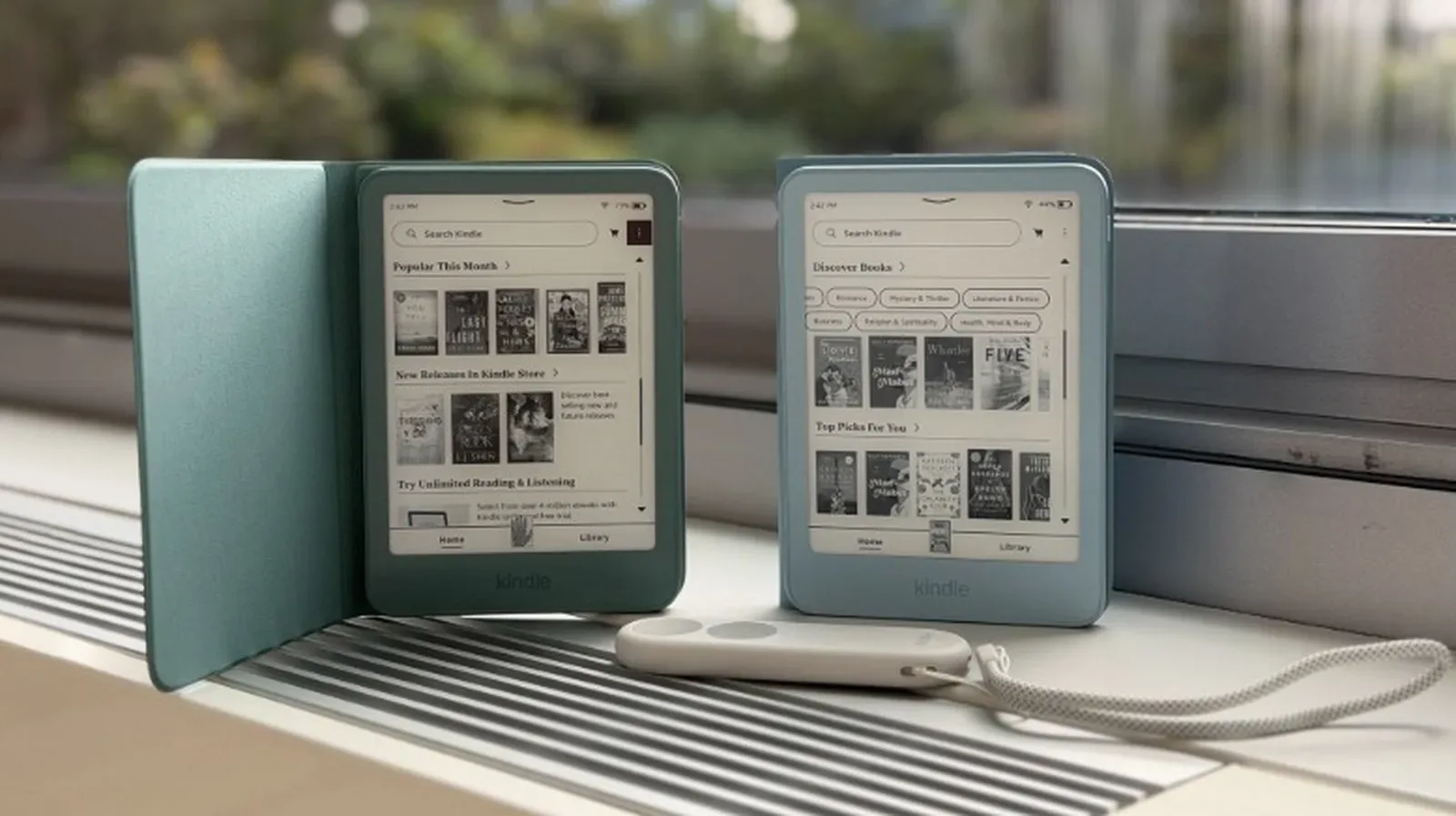 An older Kindle e-reader displaying a book beside a USB charging cable
