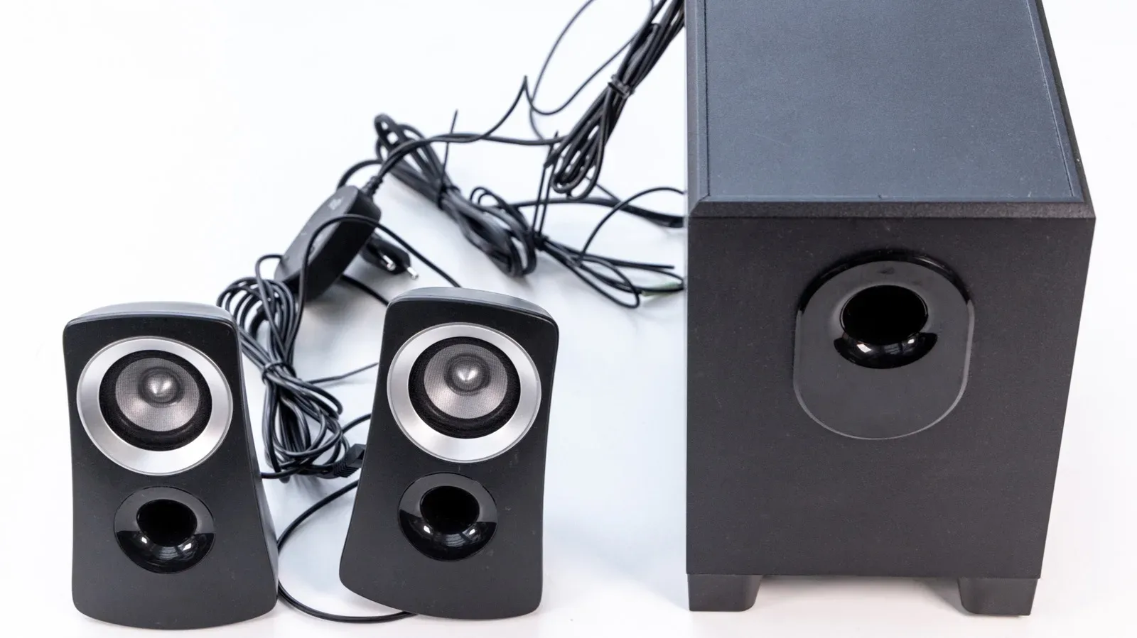 A pair of old bookshelf speakers positioned on either side of a television