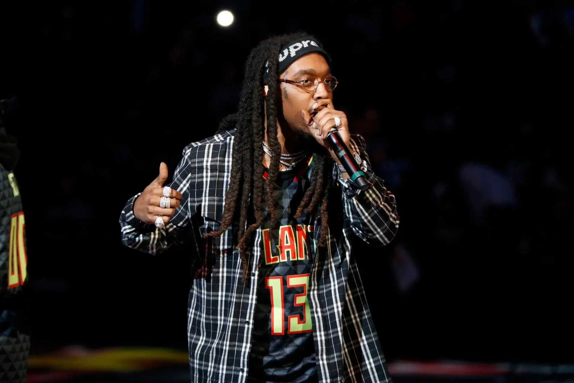 Takeoff performing onstage with Migos