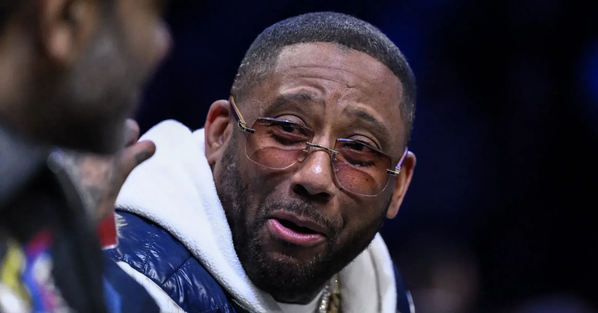 Maino dressed as Rick Ross in a Halloween parody video with oversized sunglasses and a fake beard