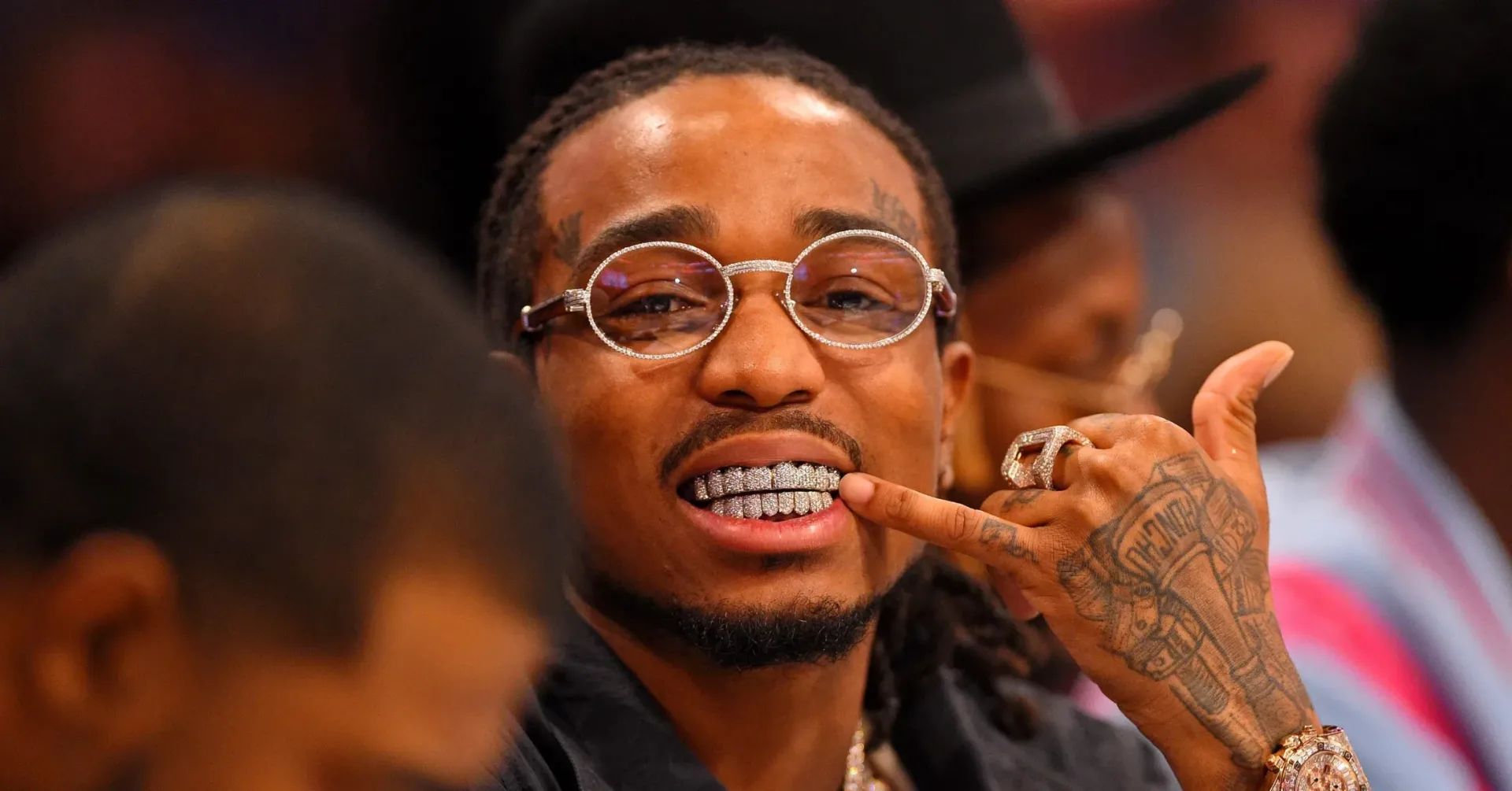 Quavo performing onstage during a live music event