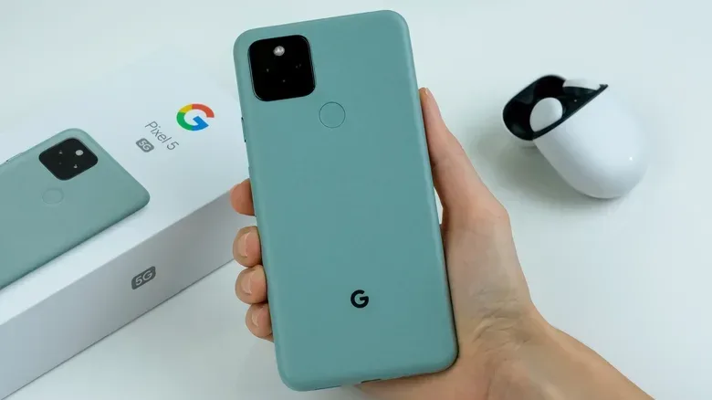 Google Pixel 5 in Sorta Sage color, alongside pixel buds.