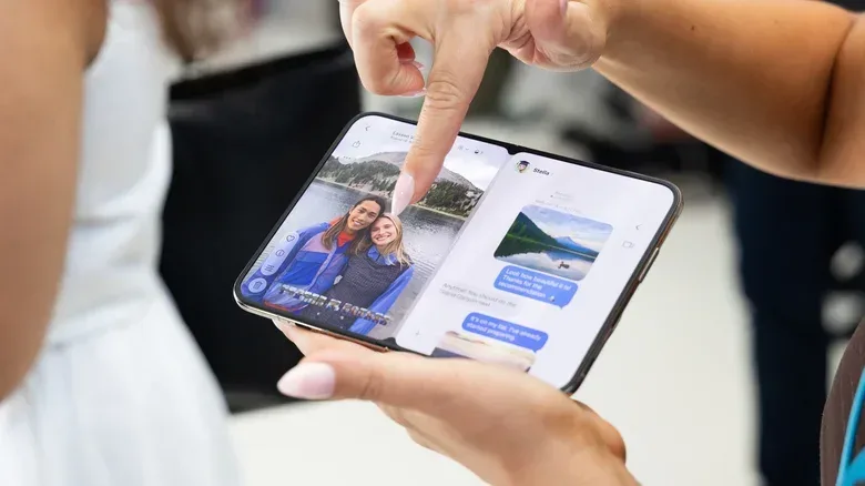 Screen protector being aligned on the hard-glass outer display of a foldable phone