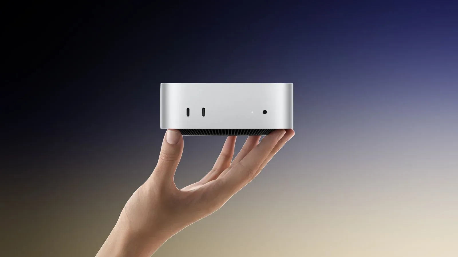 Apple Mac mini desktop computer beside a monitor