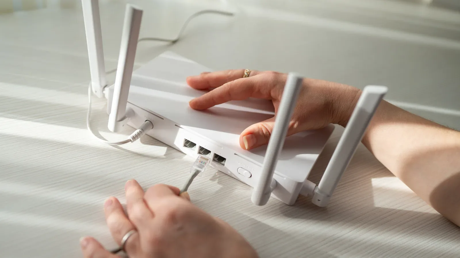 A home Wi-Fi router positioned centrally near a gaming PC setup
