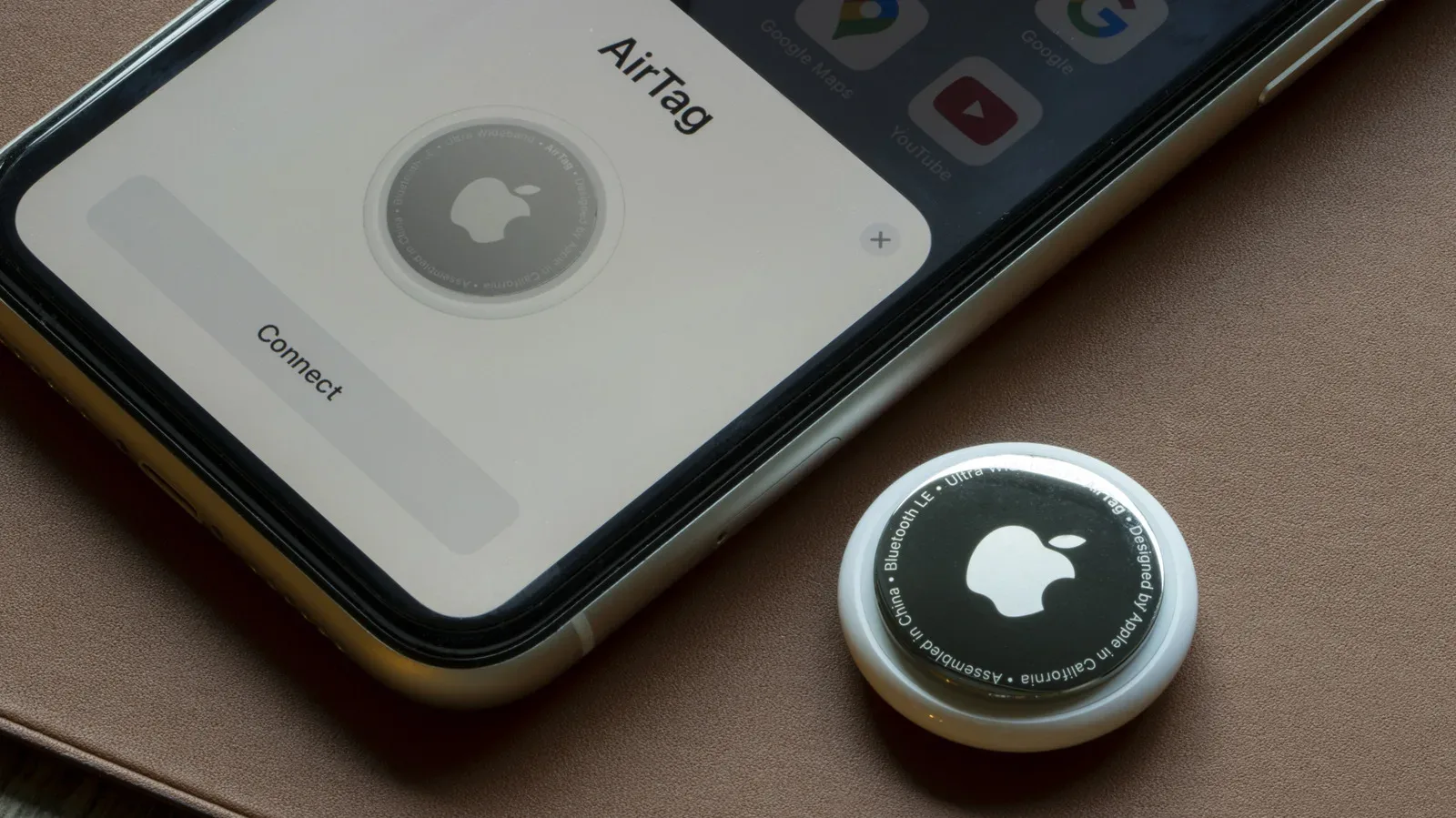 Apple AirTag placed inside a packed checked suitcase