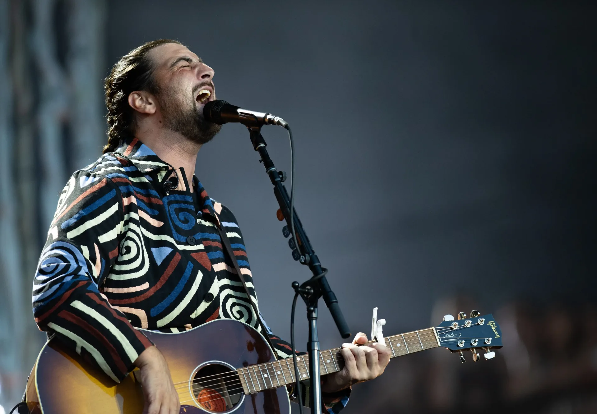 Noah Kahan performs onstage during a stadium concert