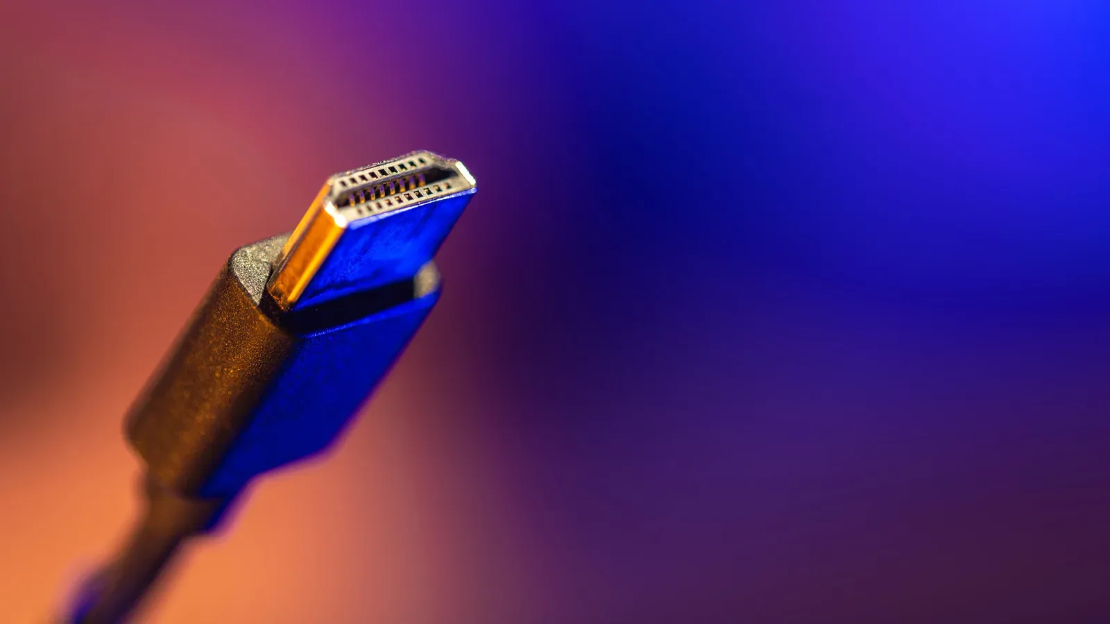 A long HDMI cable connected between a gaming PC and a 4K display