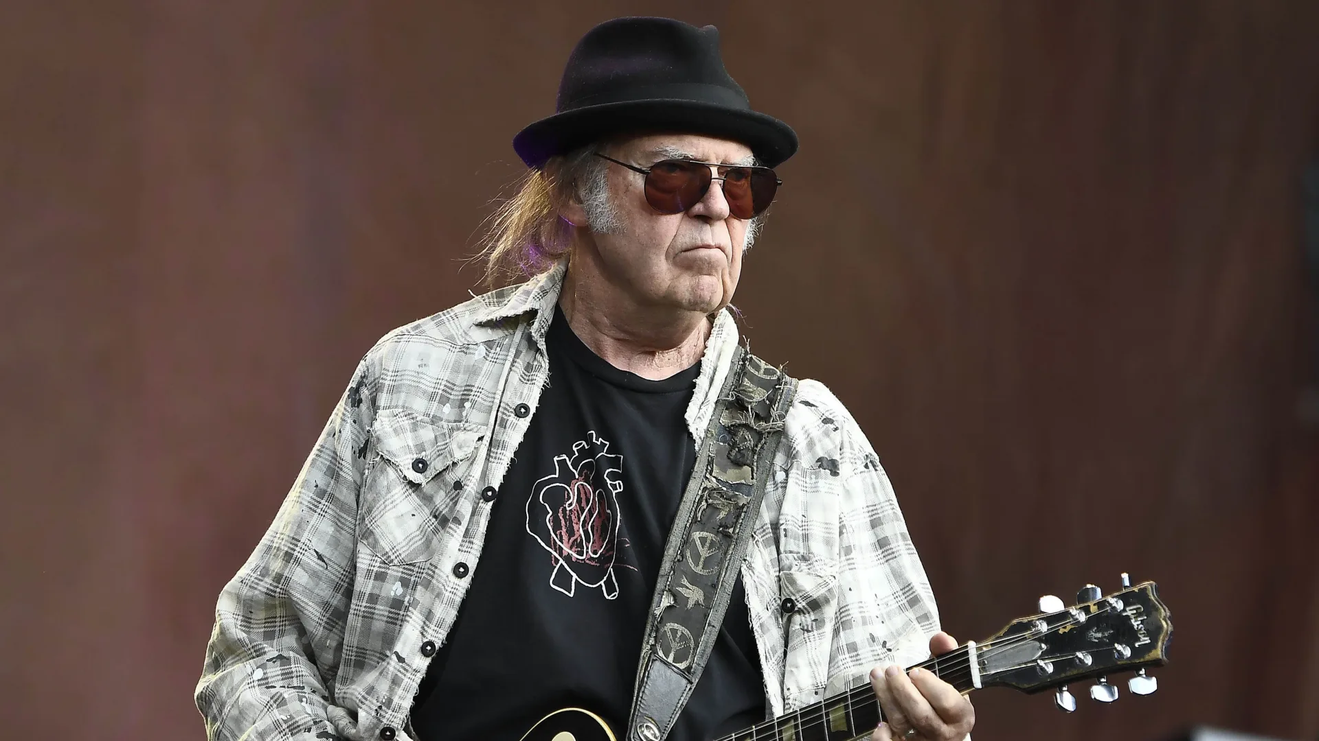 Neil Young performing onstage during a live concert