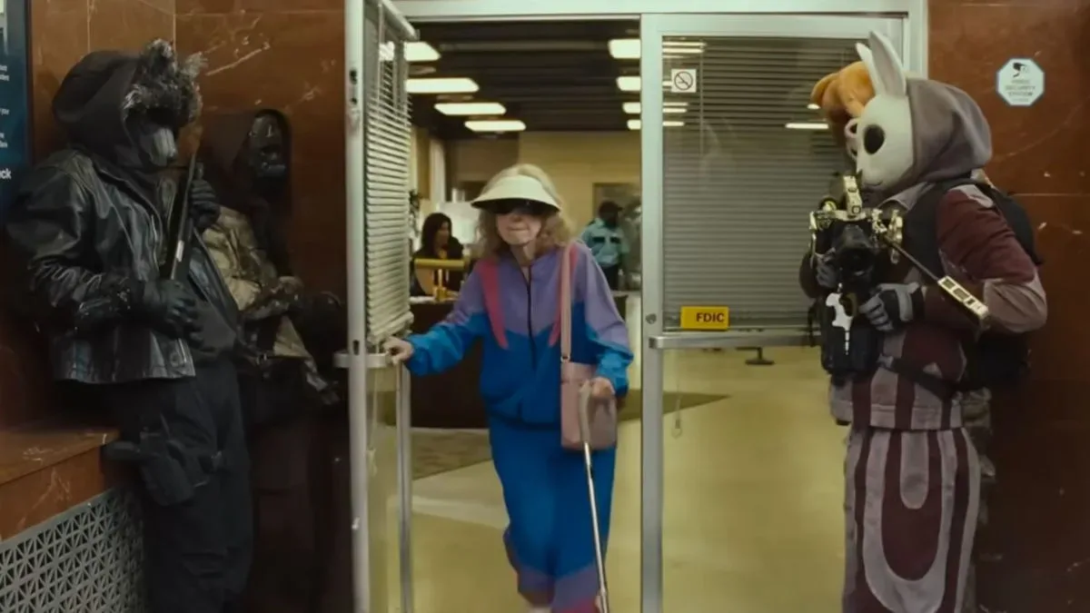 Four robbers wearing animal masks, letting a old lady leave a bank before they go and rob it in the trailer for the movie, How to Rob a Bank.