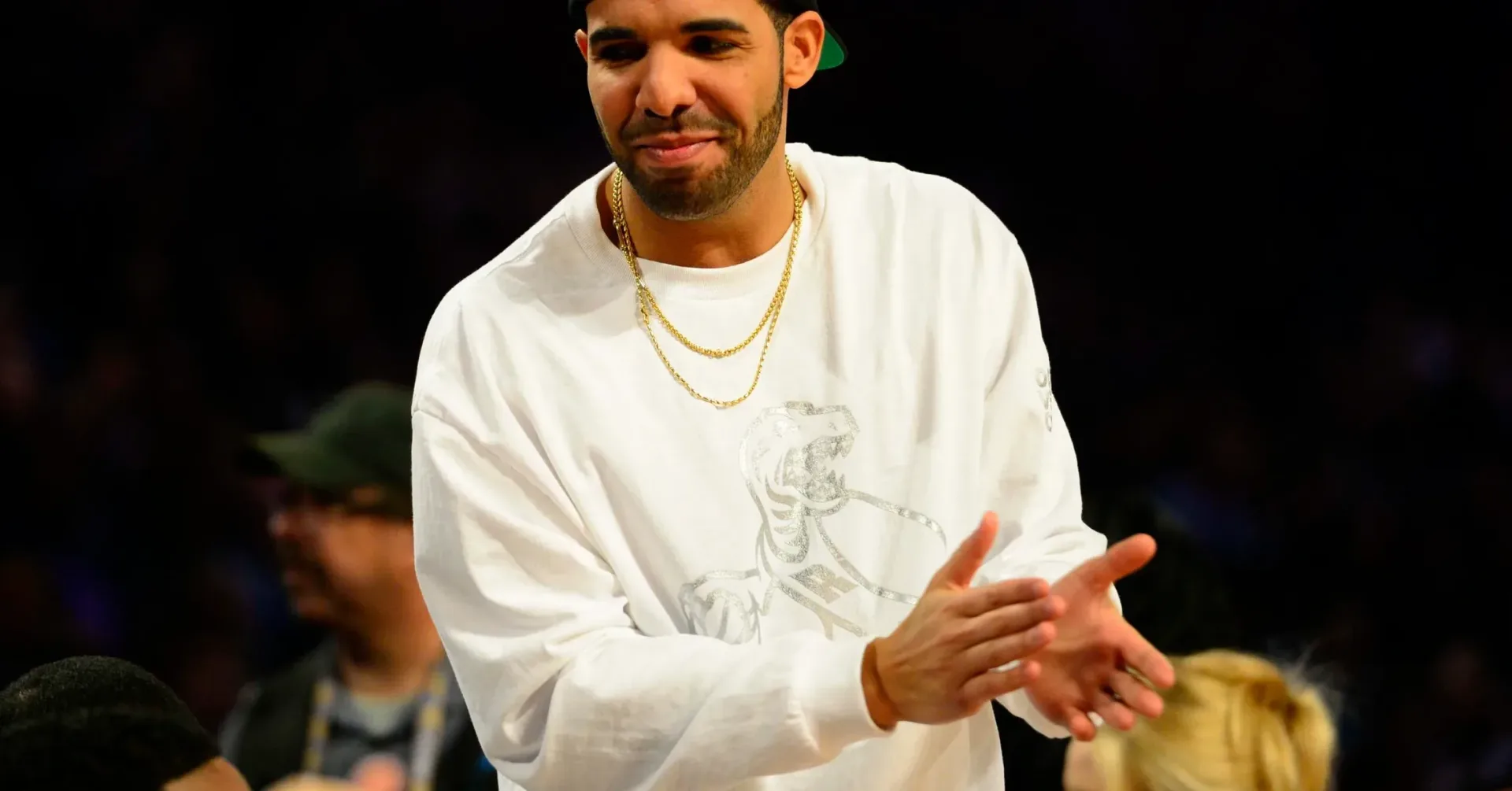 Drake wearing a Chrome Hearts leopard-print jacket with red leather pants at his birthday celebration