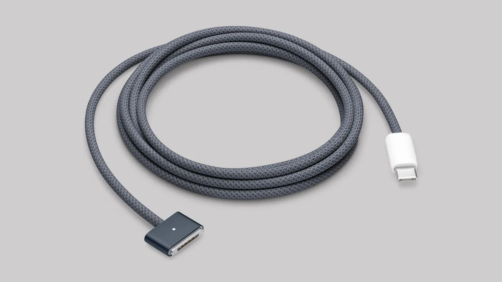 USB-C to MagSafe 3 charging cable connected to a MacBook and power adapter