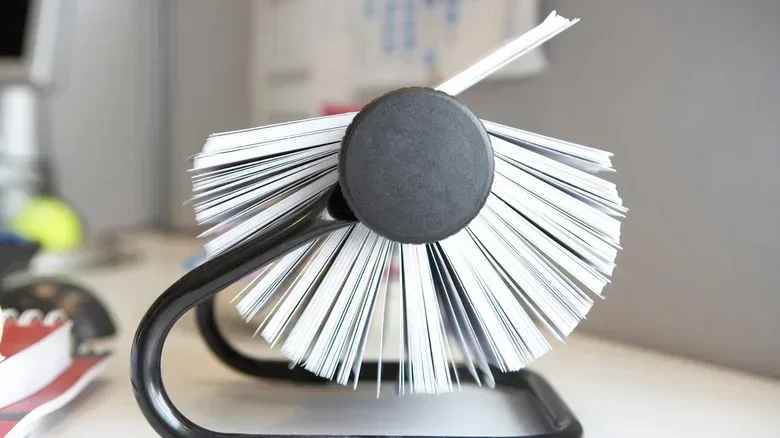 Side view of a Rolodex sitting on a desk.