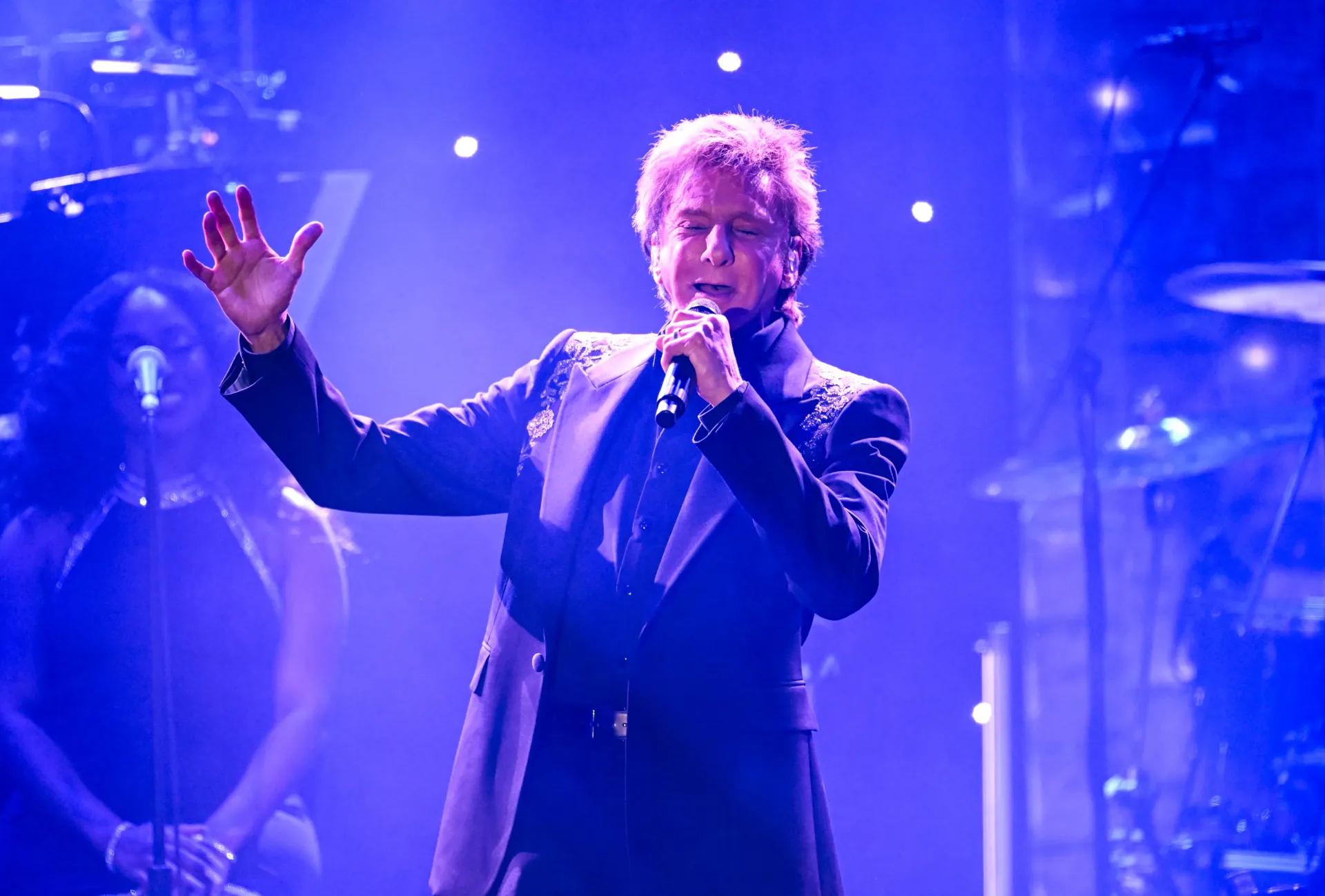Barry Manilow performing onstage at a Las Vegas concert venue