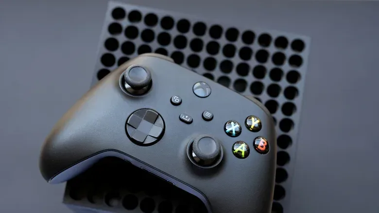 Close-up of an Xbox Series X controller being cleaned with a soft cloth