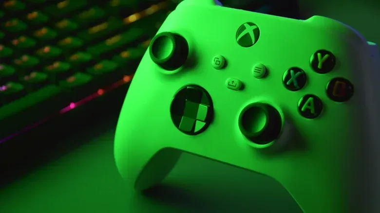 White Xbox controller in green light.