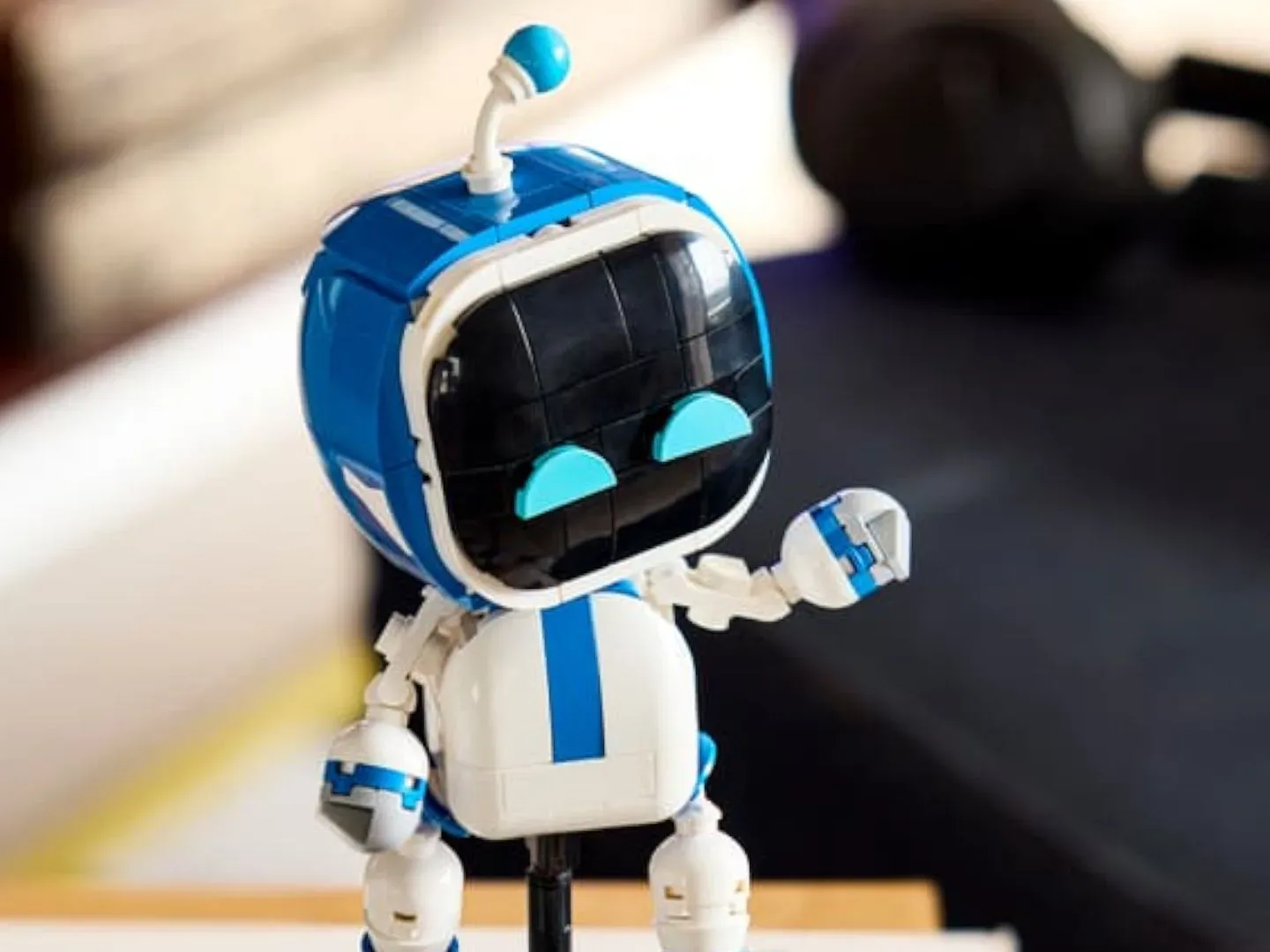 Lego Astro Bot waving in a home environment