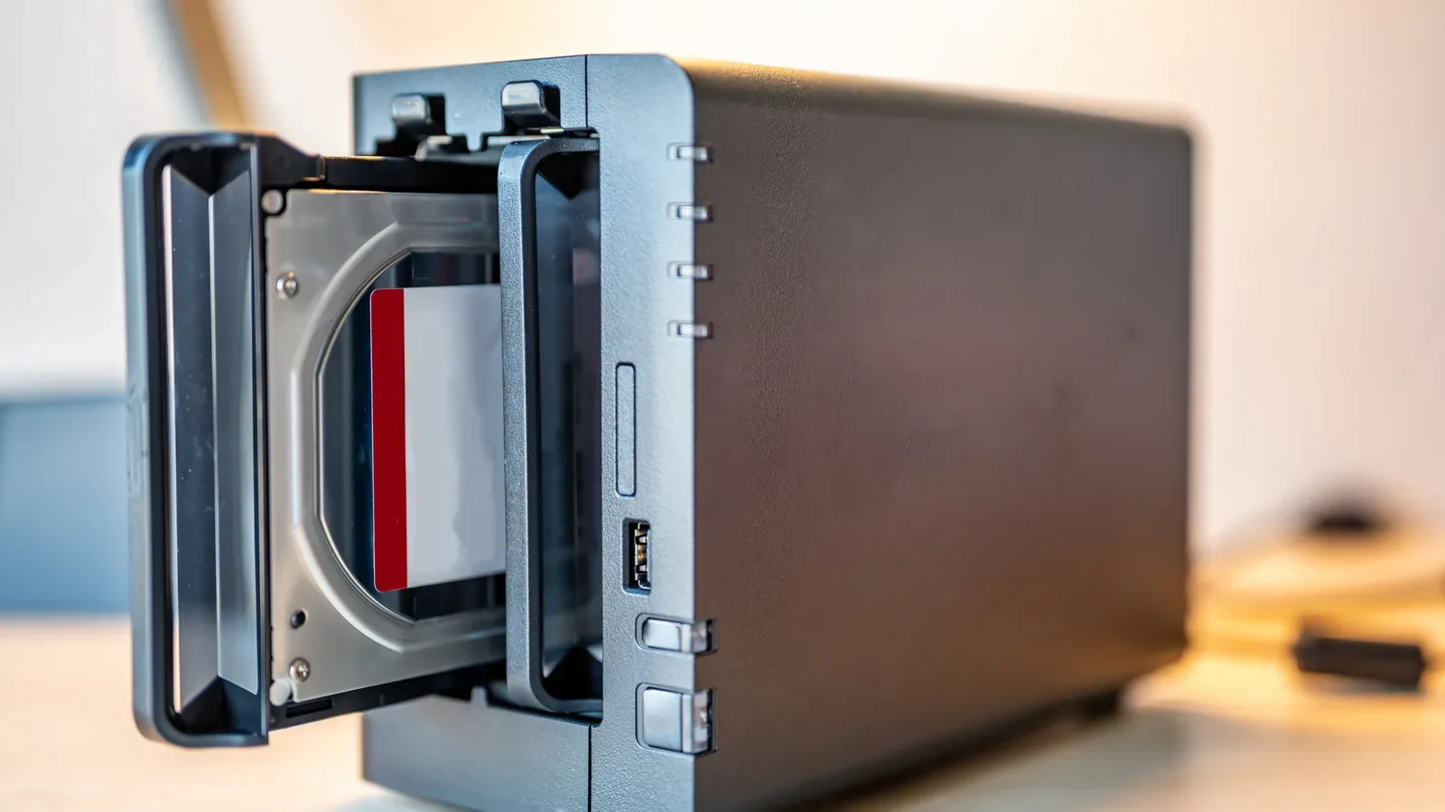 Several older hard drives arranged beside a PC storage enclosure