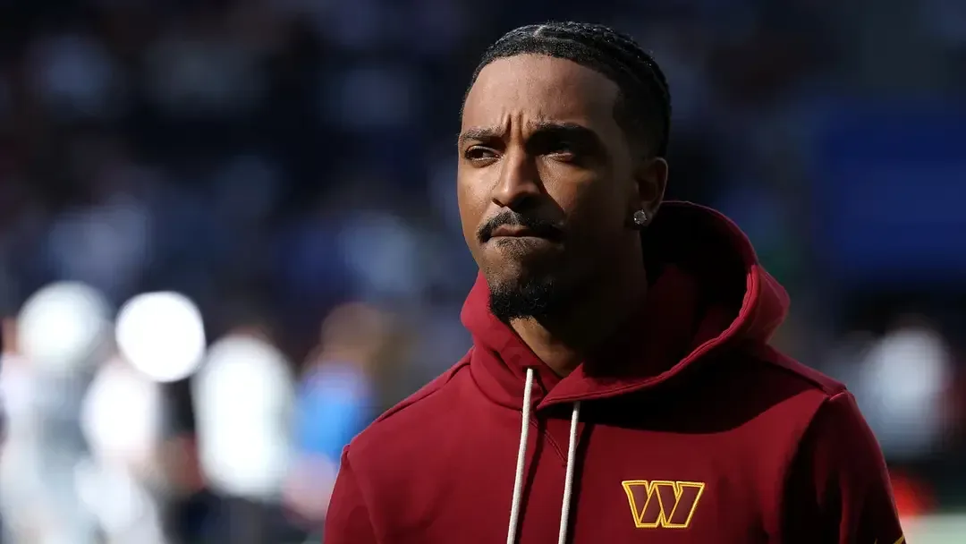 Jayden Daniels walking off the field during Commanders warmups in Tottenham