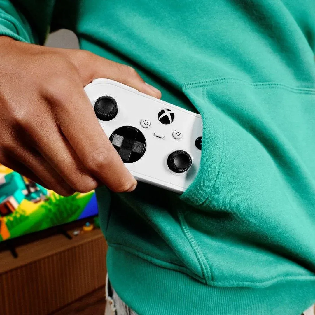 An Xbox Nano Controller being pulled out of a kid's hoodie pocket