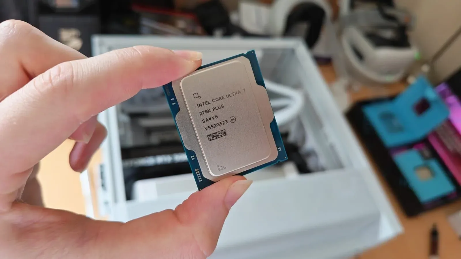 A reviewer holding the Intel Core Ultra 7 270K Plus