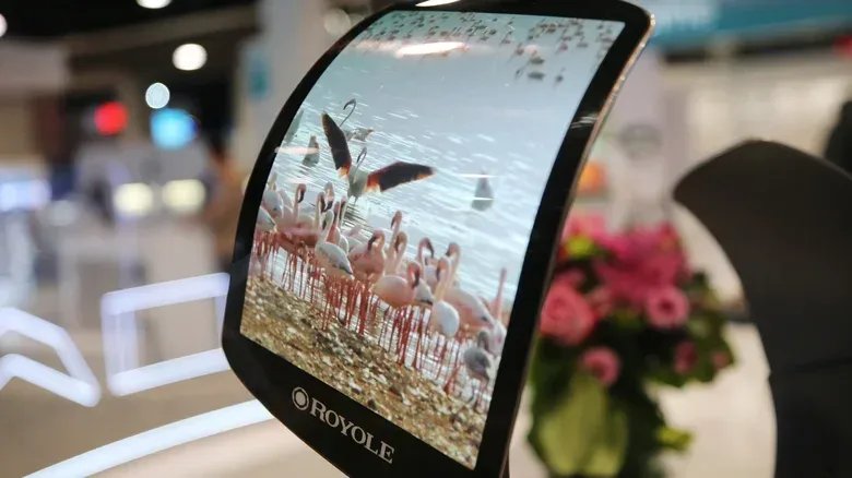 A close-up of a foldable phone hinge and lightly visible display crease