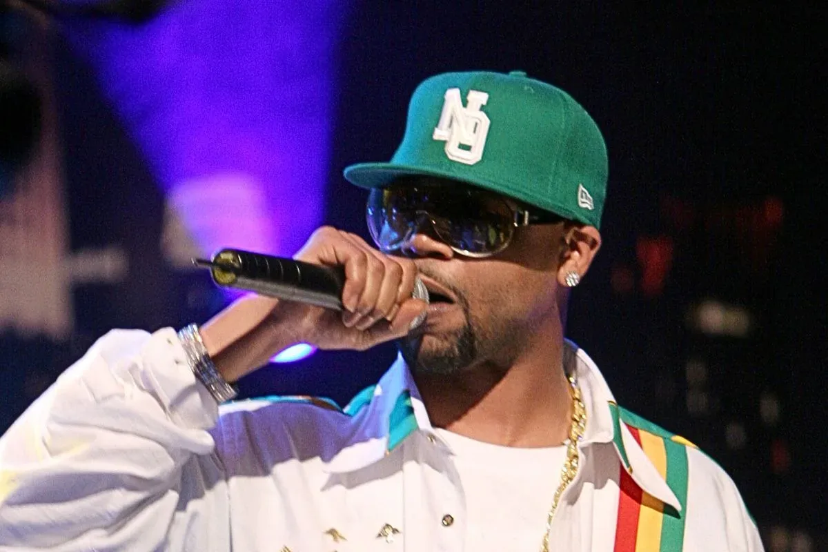 Juvenile performing with a live band during a concert set