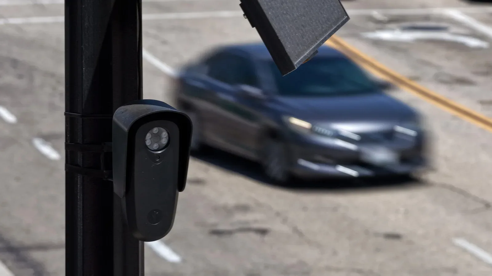 A roadside license plate-reader camera mounted on a pole