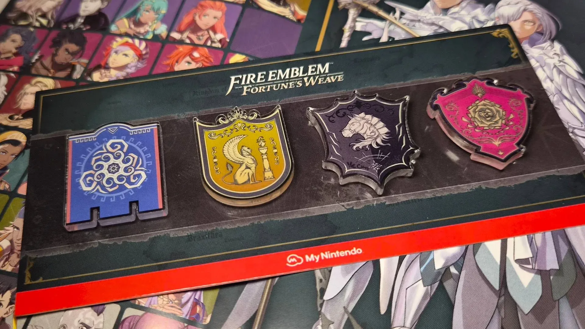 Four Fire Emblem: Fortune’s Weave acrylic magnets featuring the Ribeira Winds, Megaria’s Beacon, House Lamine and Rose Tempest banners