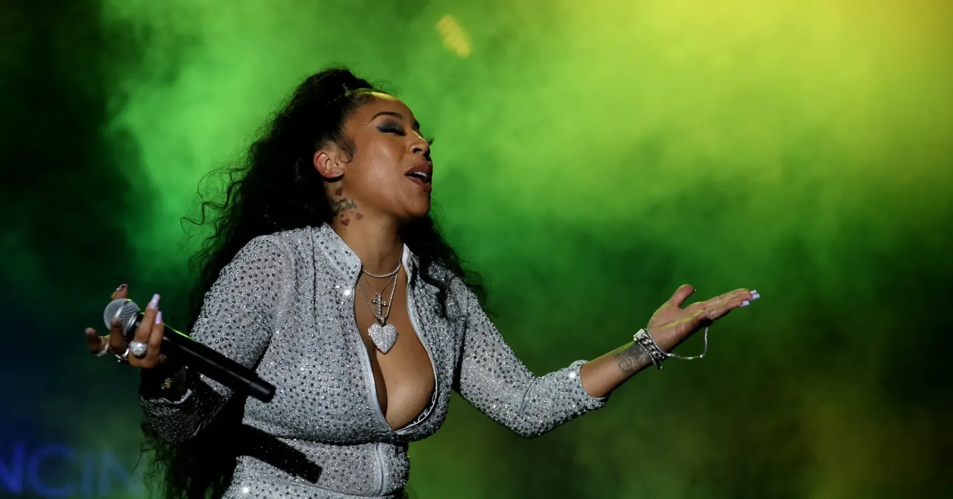 Skrilla and Keyshia Cole in a social-media post showing Skrilla’s upper-back tattoo reading “Keyshia”