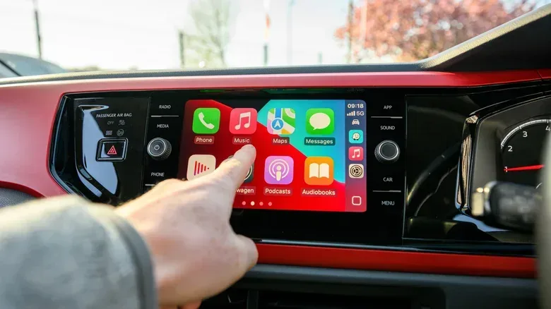 Parked electric vehicle infotainment display with Apple CarPlay interface