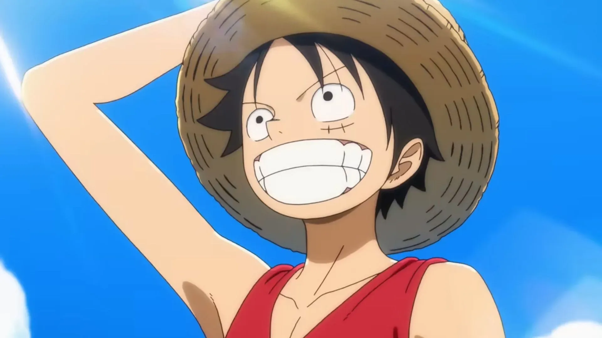 The One Piece explained: A close-up of Luffy smiling while holding his hat in a screenshot of the upcoming reboot, The One Piece