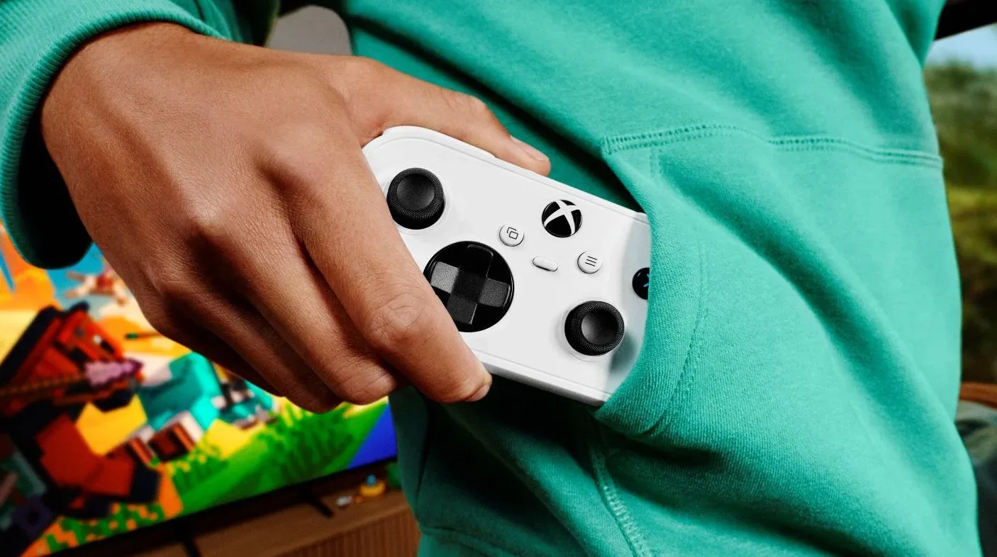 White Xbox Nano controller shown beside a standard-sized gamepad
