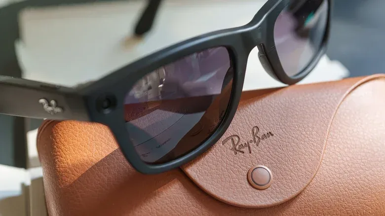 Close-up of smart glasses with a privacy-focused settings screen on a connected phone